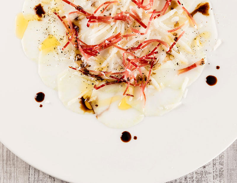 Cabbage-turnip carpaccio with speck and parmesan